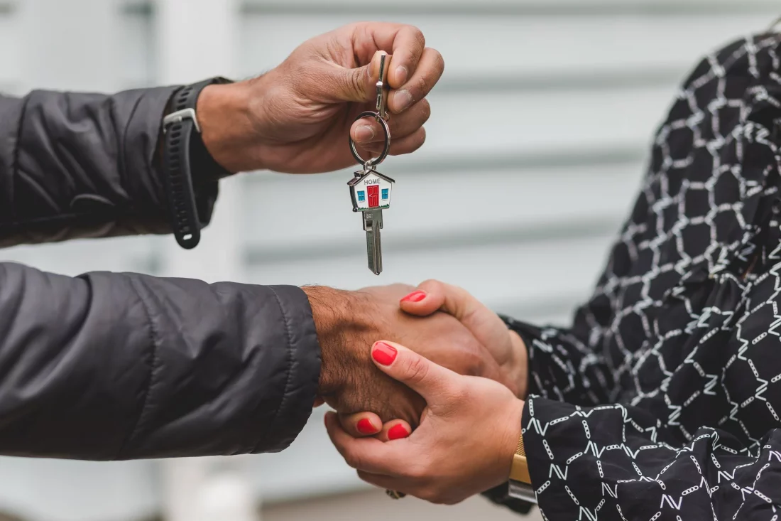 person handing over keys to home